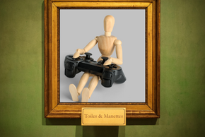 Une oeuvre d'art encadrée montre un bonhomme en bois jouant avec une manette de jeu vidéo